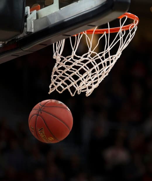 A basketball dropping through the hoop