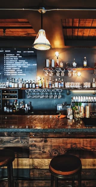 A bar counter lit by pendant lamps